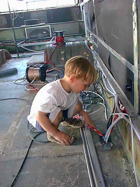 einer meiner Helfer am Bau, mein Sohn Tim der mir beim Verlegen der Batterieversorgungsleitungen hilft.